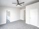 Bedroom with neutral paint and carpet, featuring a ceiling fan and closet door at 849 Brahma Ln, Henderson, NV 89002