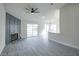 Bright living room featuring wood flooring, a fireplace with decorative paneling, and sliding glass doors at 849 Brahma Ln, Henderson, NV 89002