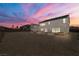 Backyard and house in sunset, featuring gravel throughout property and hot tub at 8753 Mann St, Las Vegas, NV 89139