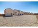 Wide view of backyard and house featuring gravel throughout the property at 8753 Mann St, Las Vegas, NV 89139