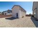 Backyard featuring detached garage, gravel throughout property, and retaining wall at 8753 Mann St, Las Vegas, NV 89139