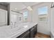 Bathroom featuring dual sinks, dark cabinets, and a marble countertop with tile flooring at 8753 Mann St, Las Vegas, NV 89139