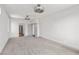 Large bedroom featuring neutral carpet, modern lighting, multiple doorways, and large open space at 8753 Mann St, Las Vegas, NV 89139