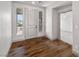 Inviting entryway with beautiful hardwood floors and bright sidelight windows flanking a modern white door at 8753 Mann St, Las Vegas, NV 89139