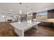 An open kitchen concept featuring a large island and sightlines to the Gathering room at 8753 Mann St, Las Vegas, NV 89139