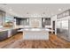 Spacious kitchen with a large island, stainless steel appliances, and dark cabinets at 8753 Mann St, Las Vegas, NV 89139