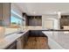 Bright, open kitchen featuring a granite countertops, stainless steel appliances, and dark wood cabinets at 8753 Mann St, Las Vegas, NV 89139