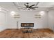 Living area highlighting a modern fireplace, floating shelves, and hardwood floors at 8753 Mann St, Las Vegas, NV 89139