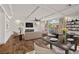A staged living room featuring hardwood floors, coffered ceilings, and a fireplace at 8753 Mann St, Las Vegas, NV 89139