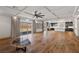 Spacious living room showcasing hardwood floors, custom shelving, and a view into the modern kitchen at 8753 Mann St, Las Vegas, NV 89139