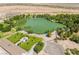 Stunning aerial perspective of a green pond surrounded by trees and manicured grounds, highlighting the property's amenities at 8808 Homestead Rd, Las Vegas, NV 89143