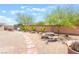 Charming backyard featuring a stone picnic table, mature trees, and a brick-lined walkway at 8808 Homestead Rd, Las Vegas, NV 89143