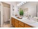 Bright bathroom featuring a double vanity, large mirror, and tile flooring at 8808 Homestead Rd, Las Vegas, NV 89143