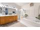 Elegant bathroom with double vanity, soaking tub, glass enclosed shower, and tile flooring at 8808 Homestead Rd, Las Vegas, NV 89143