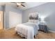 Bedroom with a queen size bed, a ceiling fan, carpet flooring, and a double door closet at 8808 Homestead Rd, Las Vegas, NV 89143