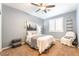 Cozy bedroom with a queen bed, a ceiling fan, carpet flooring, and a chair at 8808 Homestead Rd, Las Vegas, NV 89143