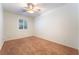 This bedroom offers carpet, a ceiling fan, and a bright window at 8808 Homestead Rd, Las Vegas, NV 89143