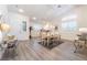 Open dining room with modern floors, wainscoting, contemporary lighting, and many windows at 8808 Homestead Rd, Las Vegas, NV 89143