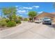 Single story home boasting mature landscaping, circular driveway, and an attached two-car garage at 8808 Homestead Rd, Las Vegas, NV 89143