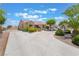 A lovely single-story home featuring well-maintained landscaping, a long driveway, and an attached garage at 8808 Homestead Rd, Las Vegas, NV 89143