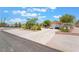 Inviting single story home with lush front yard desert landscaping, long driveway, and attached garage at 8808 Homestead Rd, Las Vegas, NV 89143