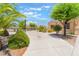 Manicured front yard with mature landscaping and a circular driveway at 8808 Homestead Rd, Las Vegas, NV 89143