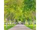 Picturesque tree-lined pathway leading to a charming gazebo surrounded by lush greenery and manicured lawns at 8808 Homestead Rd, Las Vegas, NV 89143