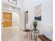 Inviting hallway featuring neutral tile flooring, chairs, and doorways leading to other rooms in the home at 8808 Homestead Rd, Las Vegas, NV 89143