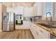 Spacious kitchen with stainless steel appliances, granite countertops, and white cabinetry, offering a modern design at 8808 Homestead Rd, Las Vegas, NV 89143