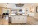 Open concept kitchen island with gas cooktop, seamless to the dining and living room, creating a welcoming atmosphere at 8808 Homestead Rd, Las Vegas, NV 89143