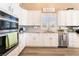 Modern kitchen featuring white cabinets, stainless steel appliances, and granite countertops, perfect for cooking and entertaining at 8808 Homestead Rd, Las Vegas, NV 89143