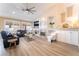 Beautiful living room featuring a fireplace, TV, modern ceiling fan, and lots of natural light from the windows at 8808 Homestead Rd, Las Vegas, NV 89143