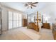Elegant main bedroom with a four-poster bed, shuttered windows, and neutral carpet, creating a tranquil retreat at 8808 Homestead Rd, Las Vegas, NV 89143