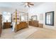 Spacious main bedroom featuring a four-poster bed, neutral color palette, and carpet flooring at 8808 Homestead Rd, Las Vegas, NV 89143