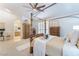 Bright main bedroom with a four-poster bed, carpet flooring, and access to the ensuite bathroom at 8808 Homestead Rd, Las Vegas, NV 89143
