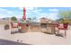 Outdoor kitchen with a built-in grill, stainless steel refrigerator, and bar seating, perfect for outdoor entertaining at 8808 Homestead Rd, Las Vegas, NV 89143