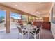 Inviting covered patio with a dining area, outdoor kitchen, and hot tub for relaxing and entertaining guests at 8808 Homestead Rd, Las Vegas, NV 89143