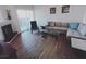 Bright living room with hardwood floors, fireplace, modern sofa, and sliding glass door at 9000 Las Vegas Blvd # 1037, Las Vegas, NV 89123
