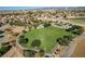A sweeping aerial view showcases a grassy public park with surrounding pathways, and residential neighborhood at 902 Cripple Creek Ct, Henderson, NV 89014