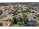 Stunning aerial view of a desert neighborhood with lush landscaping, private pools, and tile roofs at 902 Cripple Creek Ct, Henderson, NV 89014