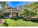 Exterior of home with a lush lawn and mature landscaping at 902 Cripple Creek Ct, Henderson, NV 89014