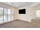 Bedroom featuring large sliding glass doors, a flat screen TV, and neutral carpeting at 902 Cripple Creek Ct, Henderson, NV 89014