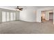 Spacious bedroom with plush carpet, ceiling fan, and sliding glass doors for ample natural light at 902 Cripple Creek Ct, Henderson, NV 89014
