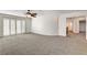 Spacious bedroom features a ceiling fan, sliding glass doors with stylish shutters, and neutral carpeting at 902 Cripple Creek Ct, Henderson, NV 89014