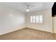 Carpeted bedroom with a ceiling fan and a window with shuttered blinds for natural light at 902 Cripple Creek Ct, Henderson, NV 89014