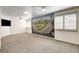 Spacious bonus room featuring plush carpets, ceiling fans, and a baseball mural at 902 Cripple Creek Ct, Henderson, NV 89014