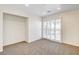 Bonus room with a sliding glass door, carpet flooring, and bright lighting at 902 Cripple Creek Ct, Henderson, NV 89014