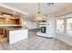 Open dining area features tile flooring, an ornate chandelier, and access to the kitchen at 902 Cripple Creek Ct, Henderson, NV 89014