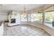 Dining area with tile floors, a modern fireplace, and panoramic views of the backyard pool at 902 Cripple Creek Ct, Henderson, NV 89014