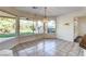Well-lit dining area with tile flooring and views of the landscaped backyard and barbecue area at 902 Cripple Creek Ct, Henderson, NV 89014